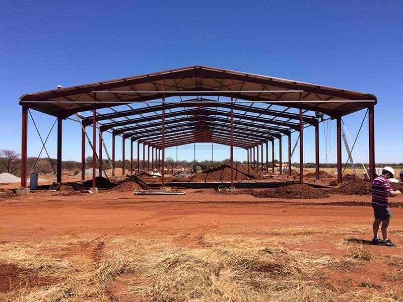 25 by 72 metre steel portal frame under erection, showing the repeating rafters of a clear-span structure by Structures 2000